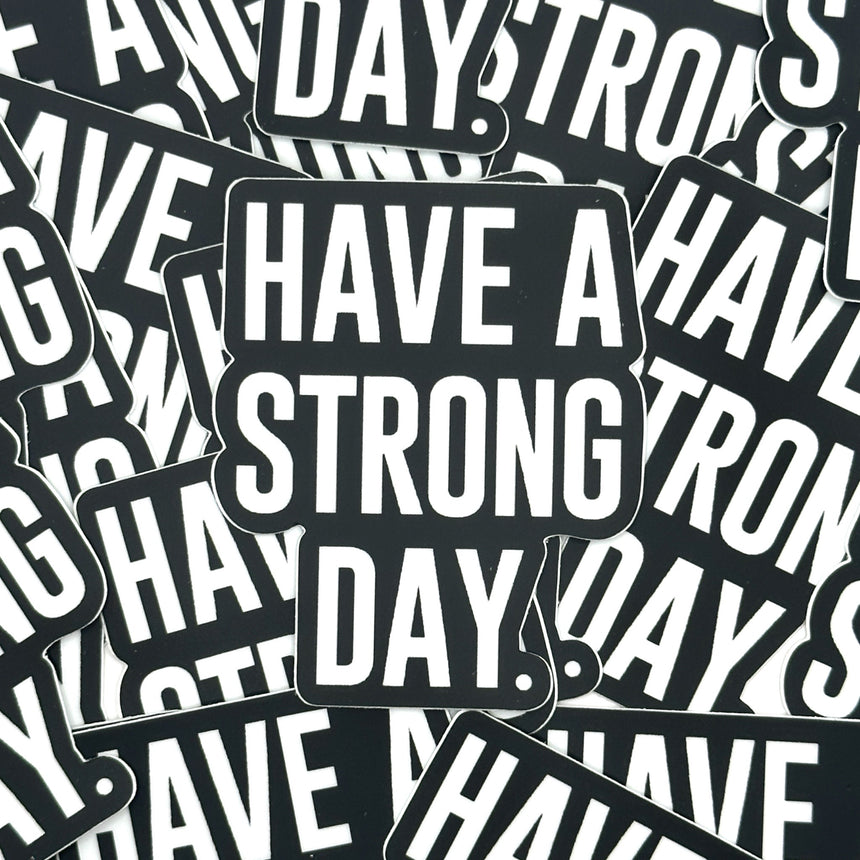 red key chain with the words have a strong day